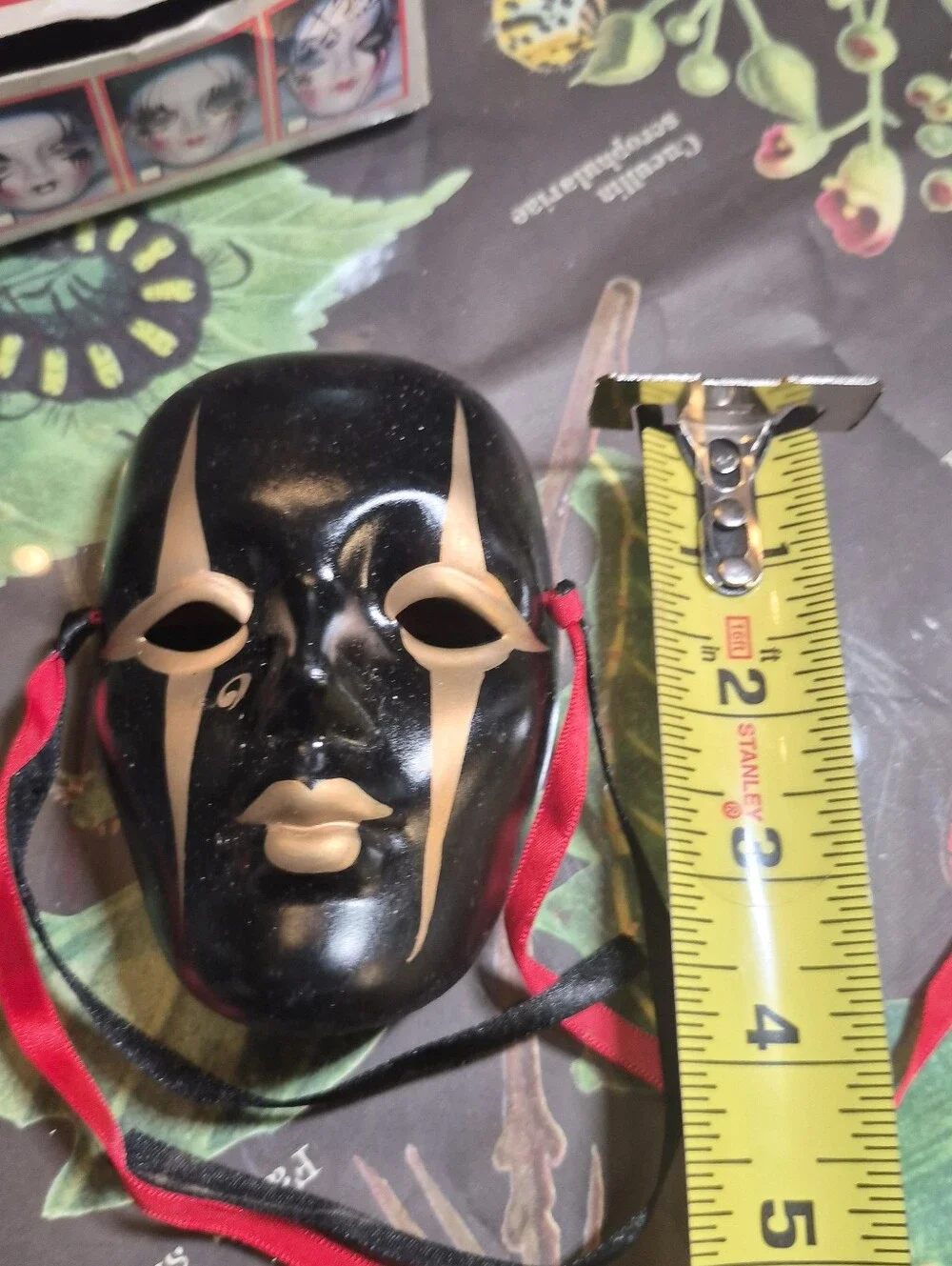 Black and Gold Decorative Venetian-Style Mask with Red & Black Ribbons